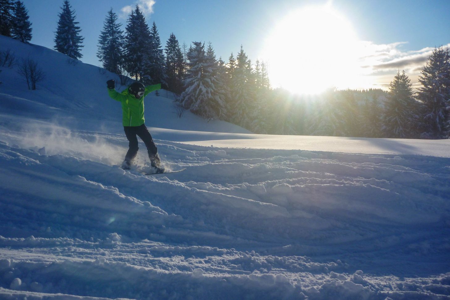 Over 30s snowboarder at sunset