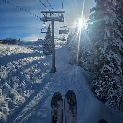 Solo skiers on a chairlift